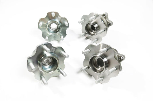 Megan Racing 5-lug conversion hubs for Nissan 240SX S13, metallic silver finish, four-piece set.