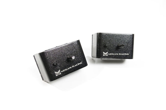 Black Megan Racing engine mounts for Nissan Skyline R32, R33, and R34, featuring hardened rubber construction.