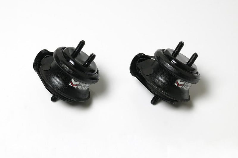 Load image into Gallery viewer, Two black Megan Racing hardened engine mounts for Nissan Skyline R33 and R34 with branded labels on white background.
