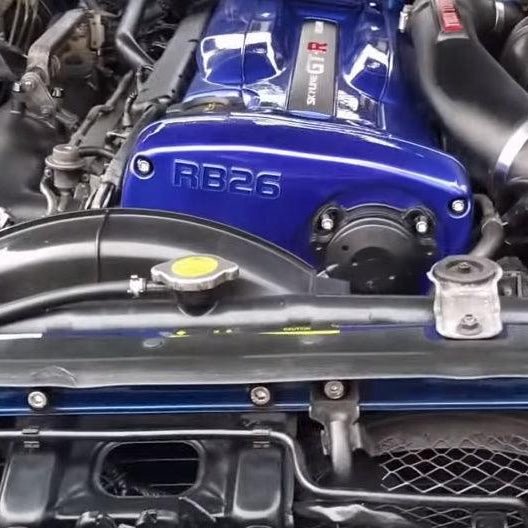 Cargue la imagen en el visor de la galería, ZSPEC stainless bolt kit on a blue RB26 engine in a Nissan Skyline GT-R (R32/R33/R34). Shows polished hardware detail.
