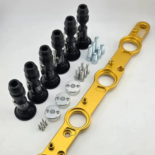 Nissan RB R35 ignition coil conversion kit featuring a gold anodized bracket, black coils, and hardware.