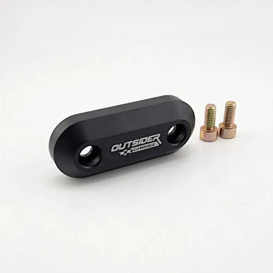 Black anodized aluminum throttle cable firewall block-off plate for Toyota Supra MKIV with two included mounting bolts.