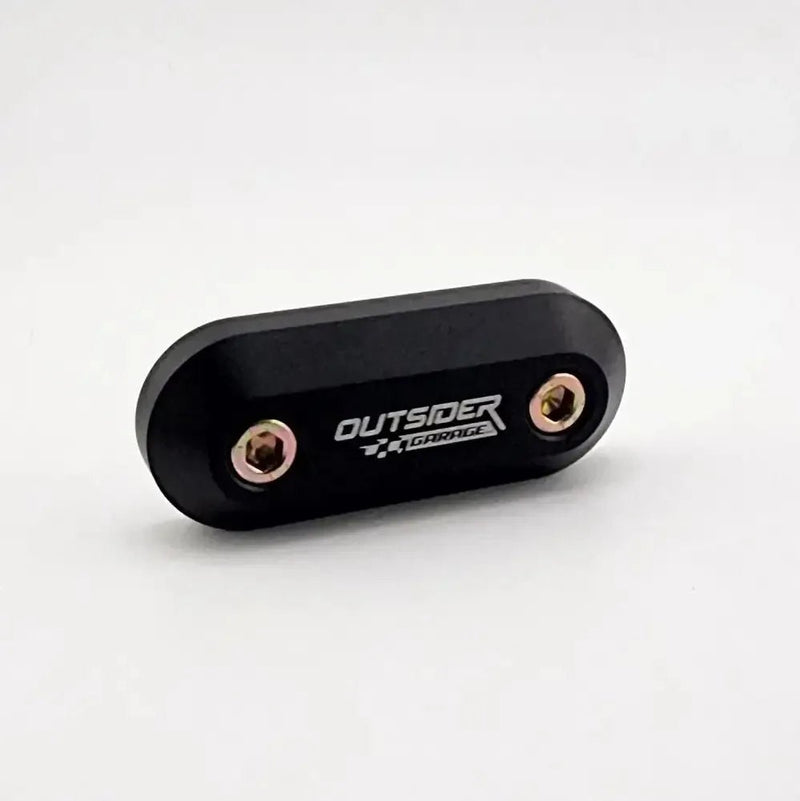 ギャラリービューアに画像をロードする, Black aluminum throttle cable firewall block-off plate for Toyota Supra MKIV with Outsider Garage logo and bolts.
