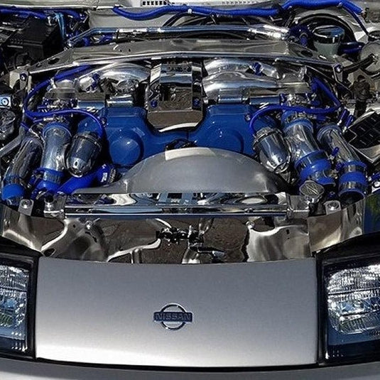 ZSPEC stainless and billet fastener kit installed on a Nissan 300zx Z32 engine bay with blue and chrome accents.