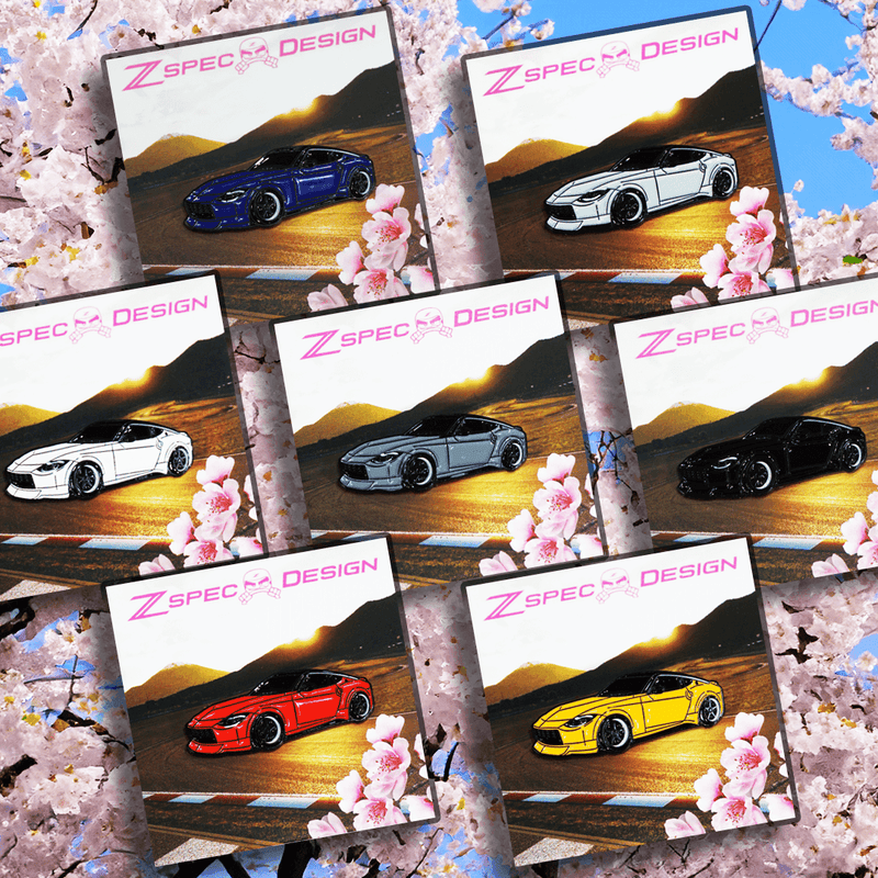 Load image into Gallery viewer, Collection of enamel collector pins featuring the Nissan Z (RZ34) in various colors against a cherry blossom background.
