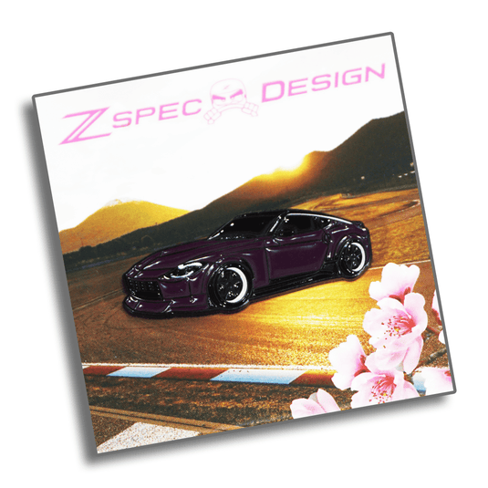 Purple Nissan Z (RZ34) enamel collector pin featuring a stylized track background with cherry blossoms.
