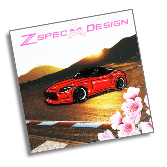 Red enamel collector pin of a Nissan Z (RZ34) on a track background with cherry blossoms.
