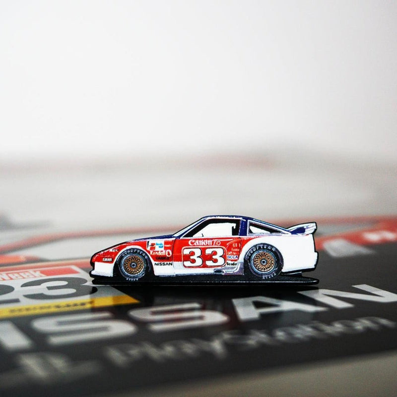 Load image into Gallery viewer, Enamel lapel pin of a red, white, and blue Nissan 300ZX Z31 #33 Newman BSR race car on a printed display card.
