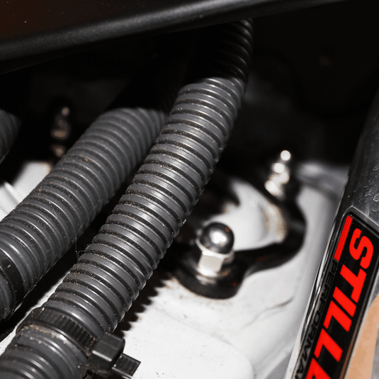ZSPEC stainless fastener kit installed on a Nissan 370z Z34, featuring polished silver acorn nuts and black washers.