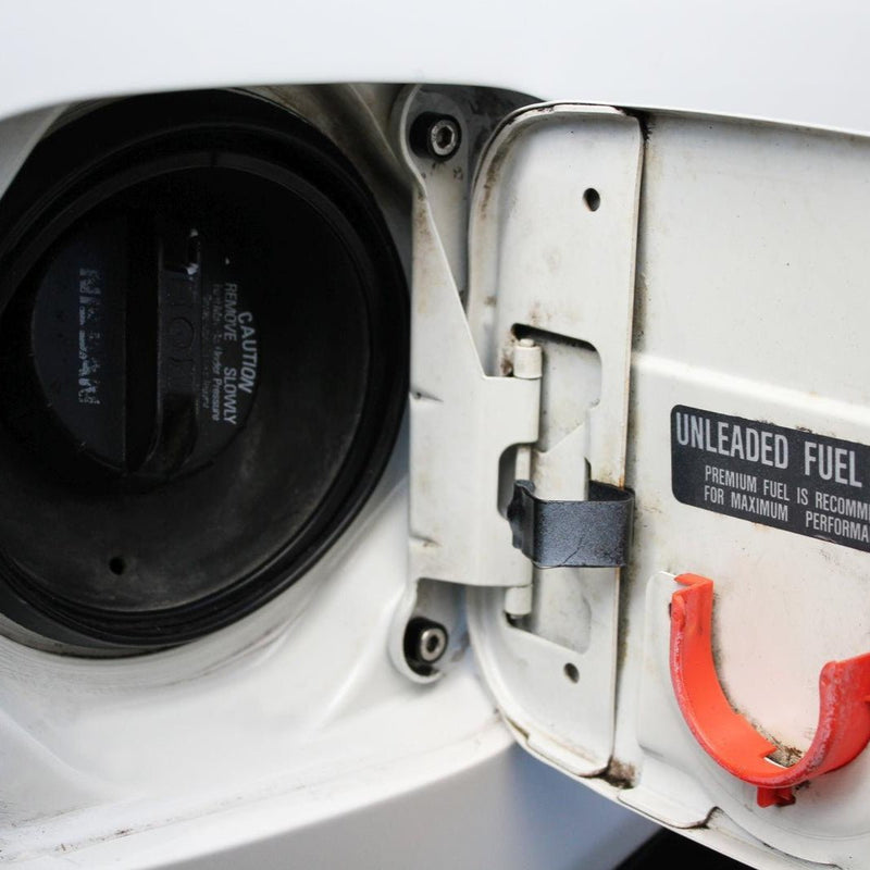 Cargue la imagen en el visor de la galería, ZSPEC Stage-2 stainless fastener kit installed on a Nissan 240SX S14 fuel door hinge, showing silver bolts.
