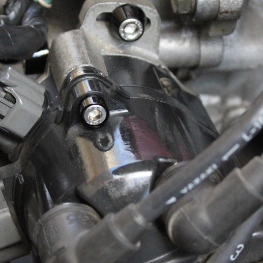 ZSPEC black billet dress-up bolts installed on a Nissan 240SX S14 engine component.