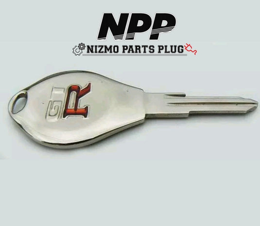 New OEM R32/R33 Skyline GT-R master key blank. Shiny silver metal with red and black GT-R logo emblem.