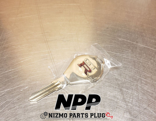 New OEM R32/R33 Nissan Skyline GT-R master key blank in a clear plastic protective sleeve.