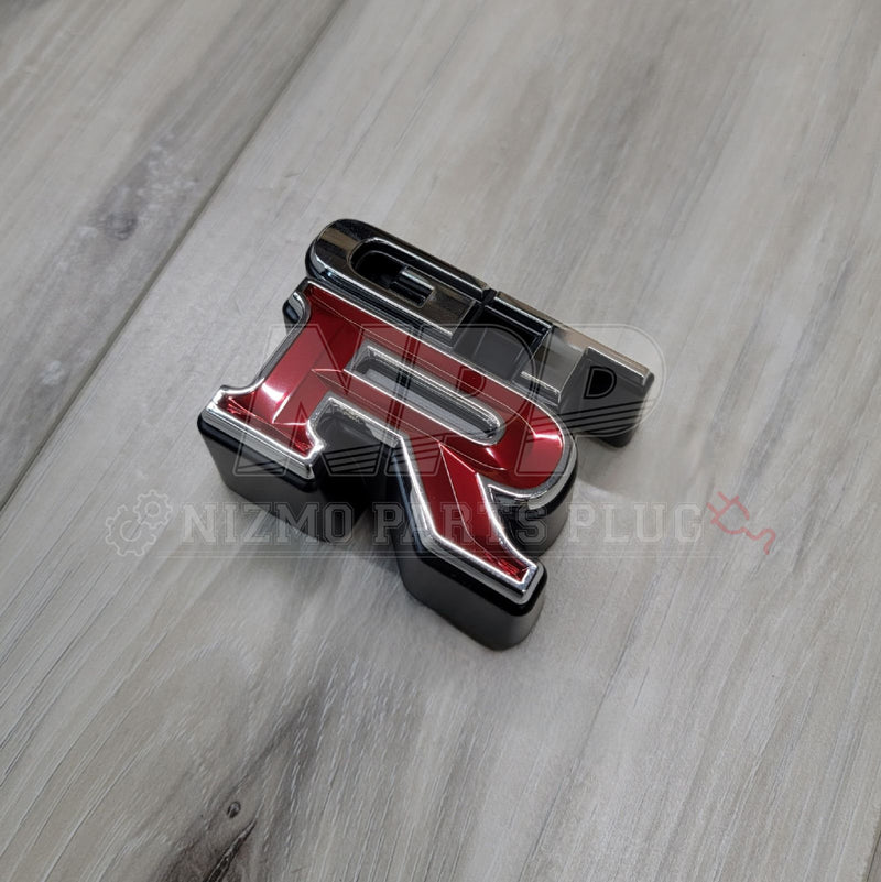 Load image into Gallery viewer, Nissan R34 Skyline GTR Front Grill Emblem - NizmoPartsPlug
