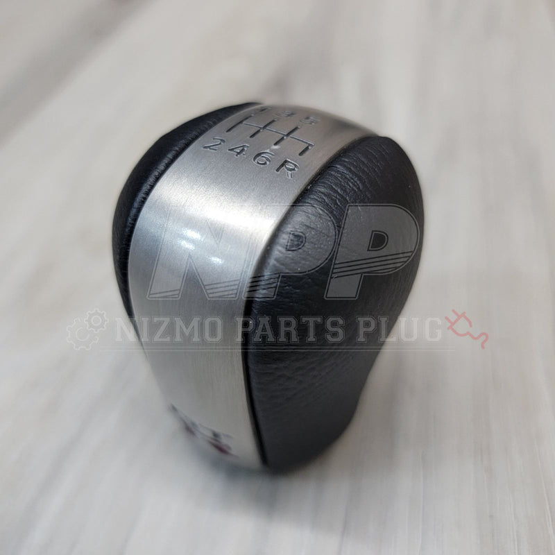 Load image into Gallery viewer, Nissan R34 Skyline GT-R Series 2 six-speed shift knob with black leather and brushed metal finish.
