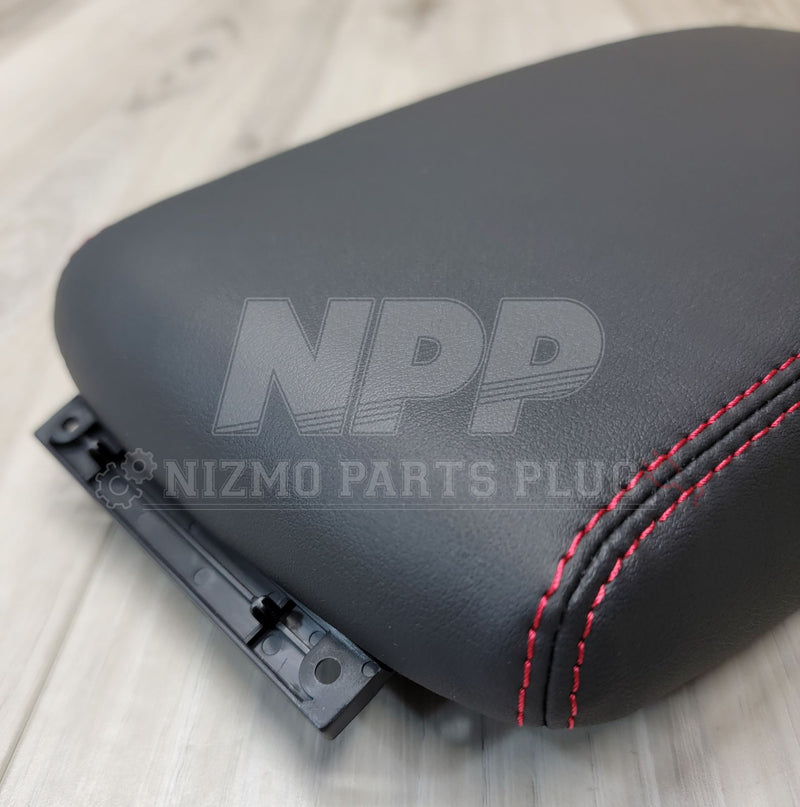 Load image into Gallery viewer, Black leather console lid for Nissan Skyline GT-R with red stitching and black mounting bracket.
