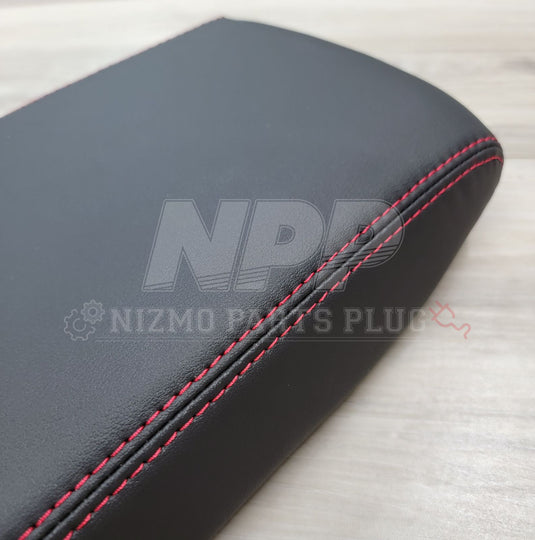 Black leather console lid for Nissan Skyline GT-R with red stitching detail.