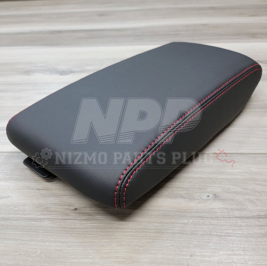 Black leather console lid for Nissan Skyline GT-R with red stitching, in new condition.