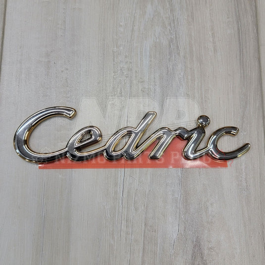 Nissan Y31 Cedric Script Front Emblem - NizmoPartsPlug