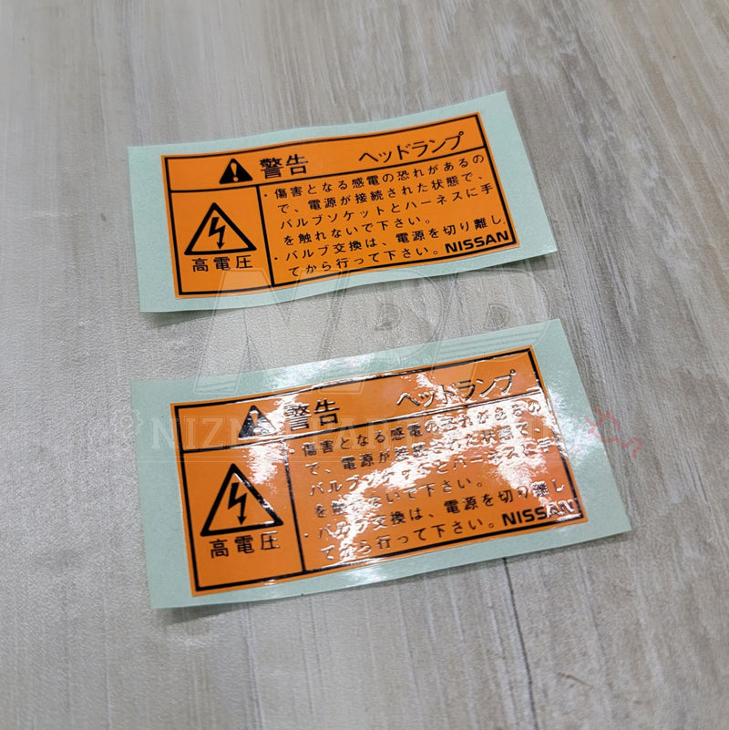 Load image into Gallery viewer, Nissan R34 Skyline Headlight H.I.D. Warning Label Set - NizmoPartsPlug
