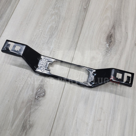 Black metal license plate lamp bracket for Nissan Skyline R34, showing clean, pre-owned condition.