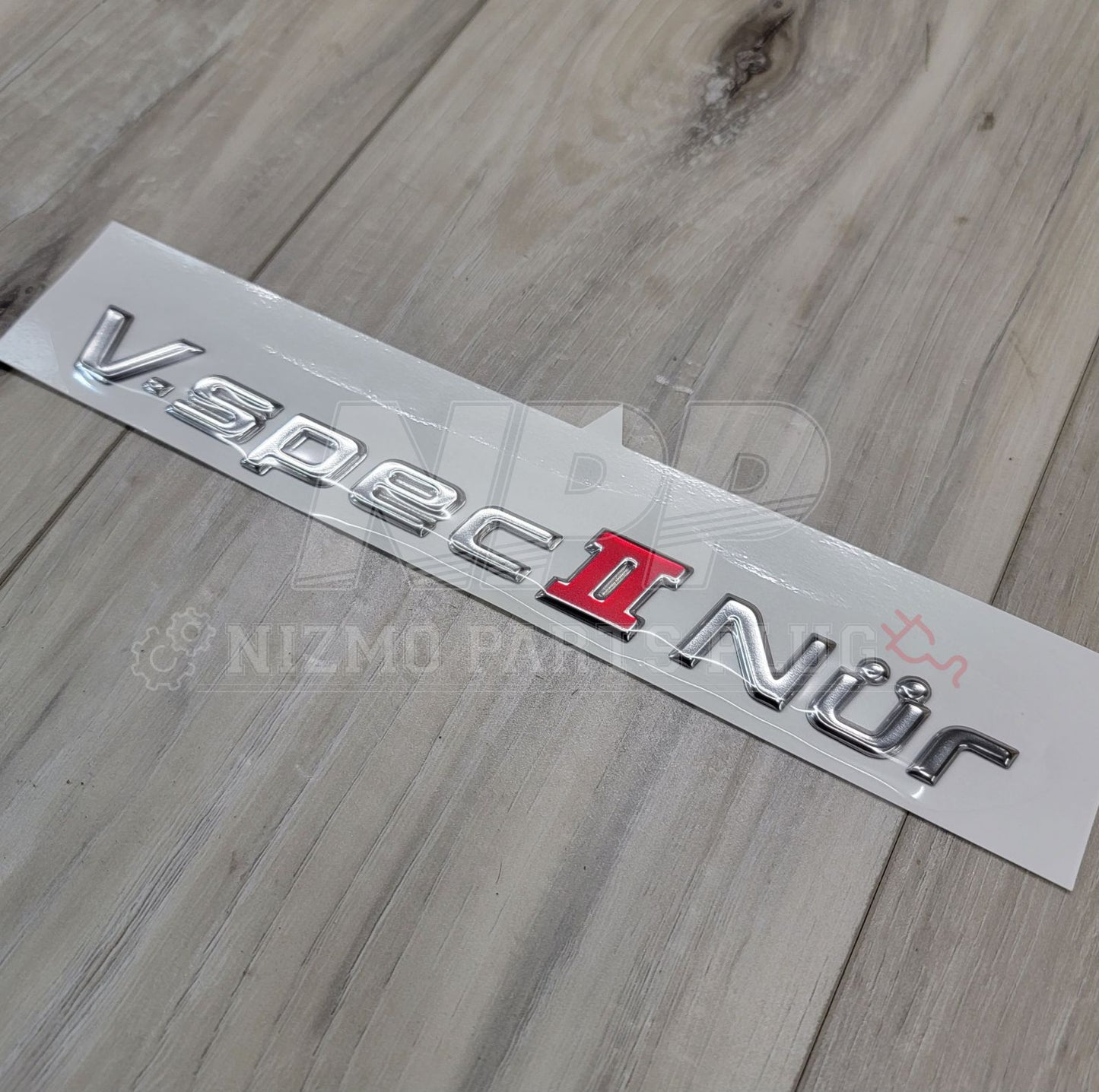 Emblema del maletero del Nissan R34 Skyline GT-R Vspec II