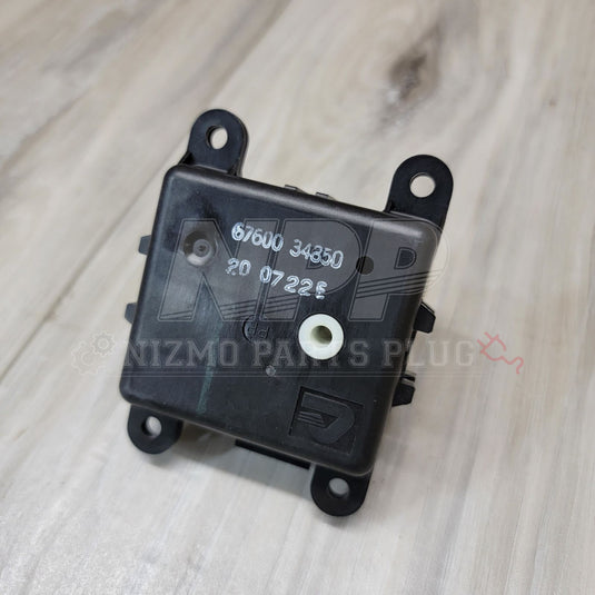 Black Nissan S14 Silvia/Stagea A/C air mix door actuator with white center gear, showing part number 67600 34350.