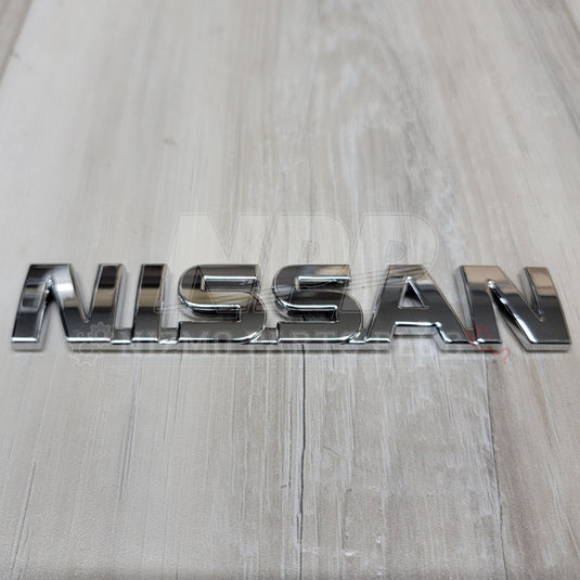 Nissan R32 Skyline "Nissan" Trunk Lid Emblem - NizmoPartsPlug