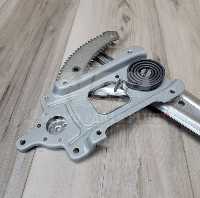 Load image into Gallery viewer, Nissan R34 Skyline LH window regulator assembly. Silver metal finish with black coil spring on a wood background.
